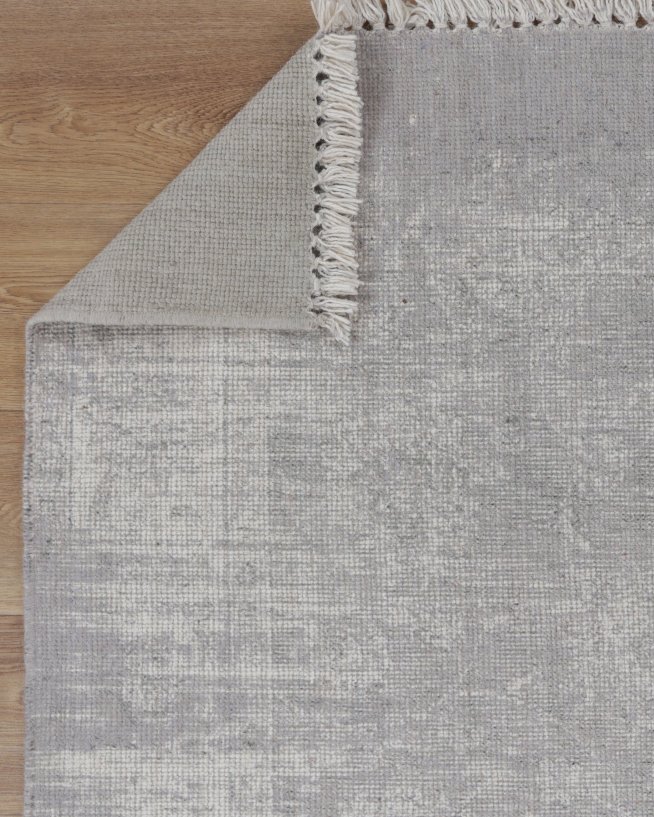 Agora Timbuktu Grey Wool Rug folded corner photo
