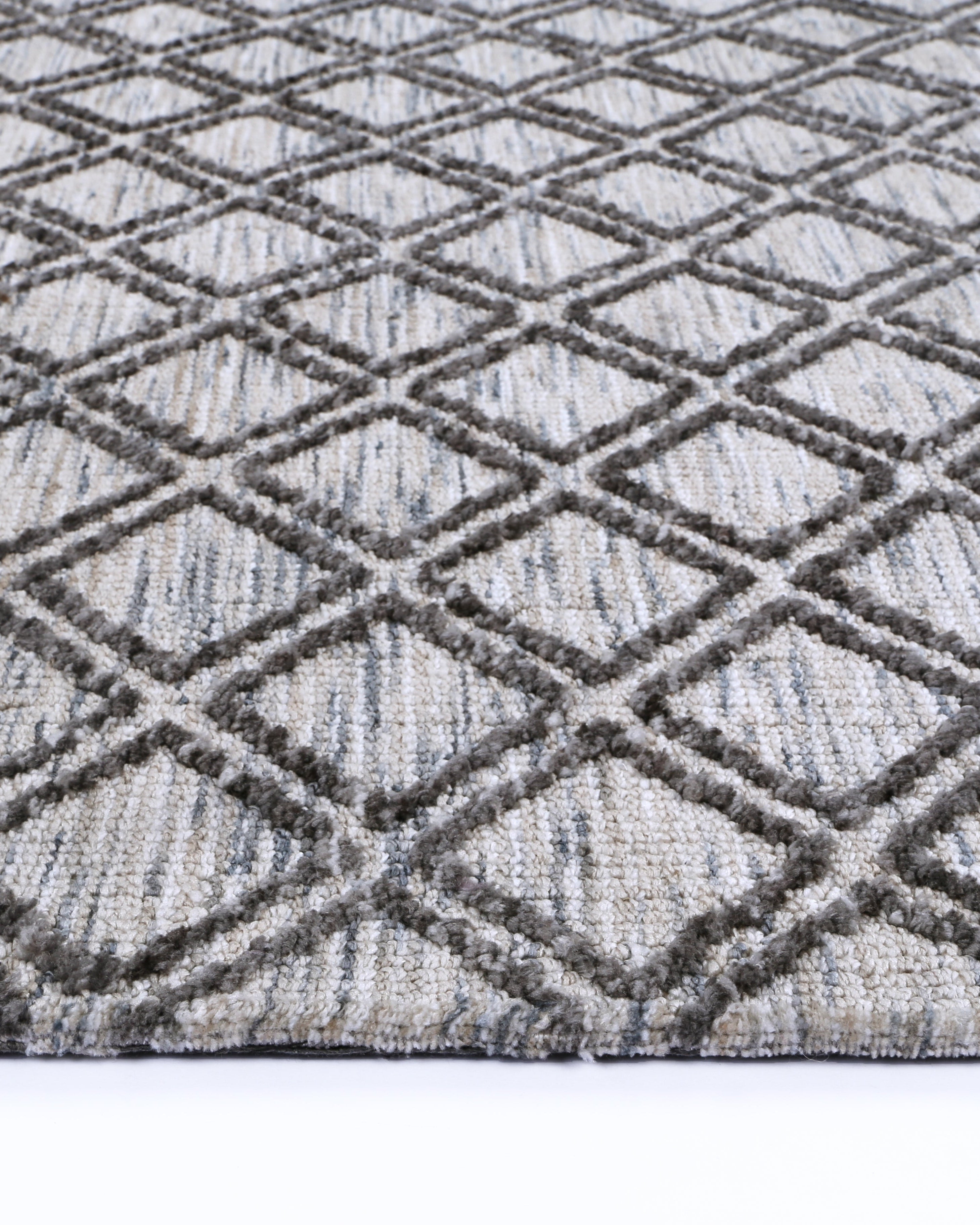 side of Alayah Diamond Trellis Grey & taupe Rug on white flooring