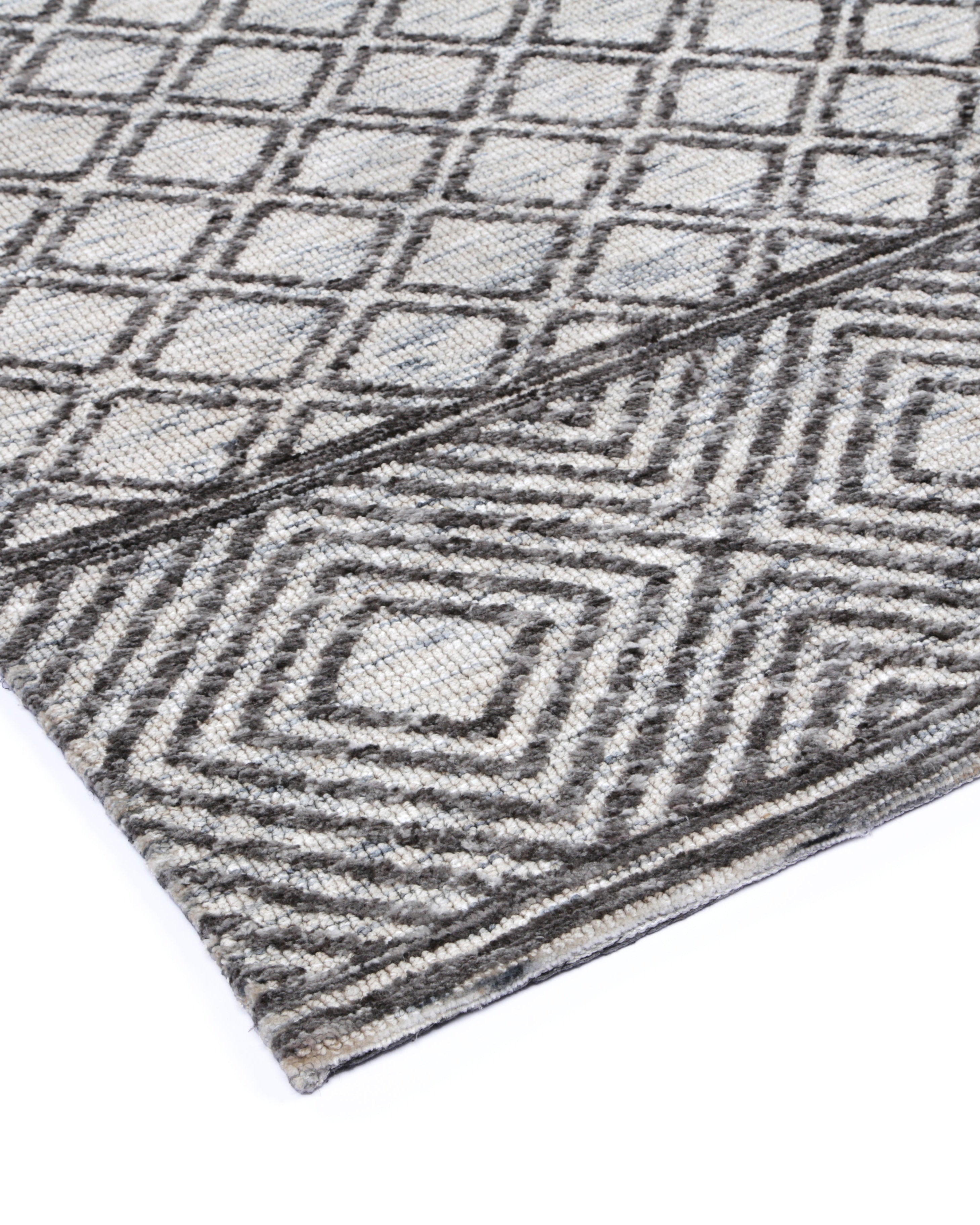 corner of Alayah Diamond Trellis Grey & taupe Rug on white flooring
