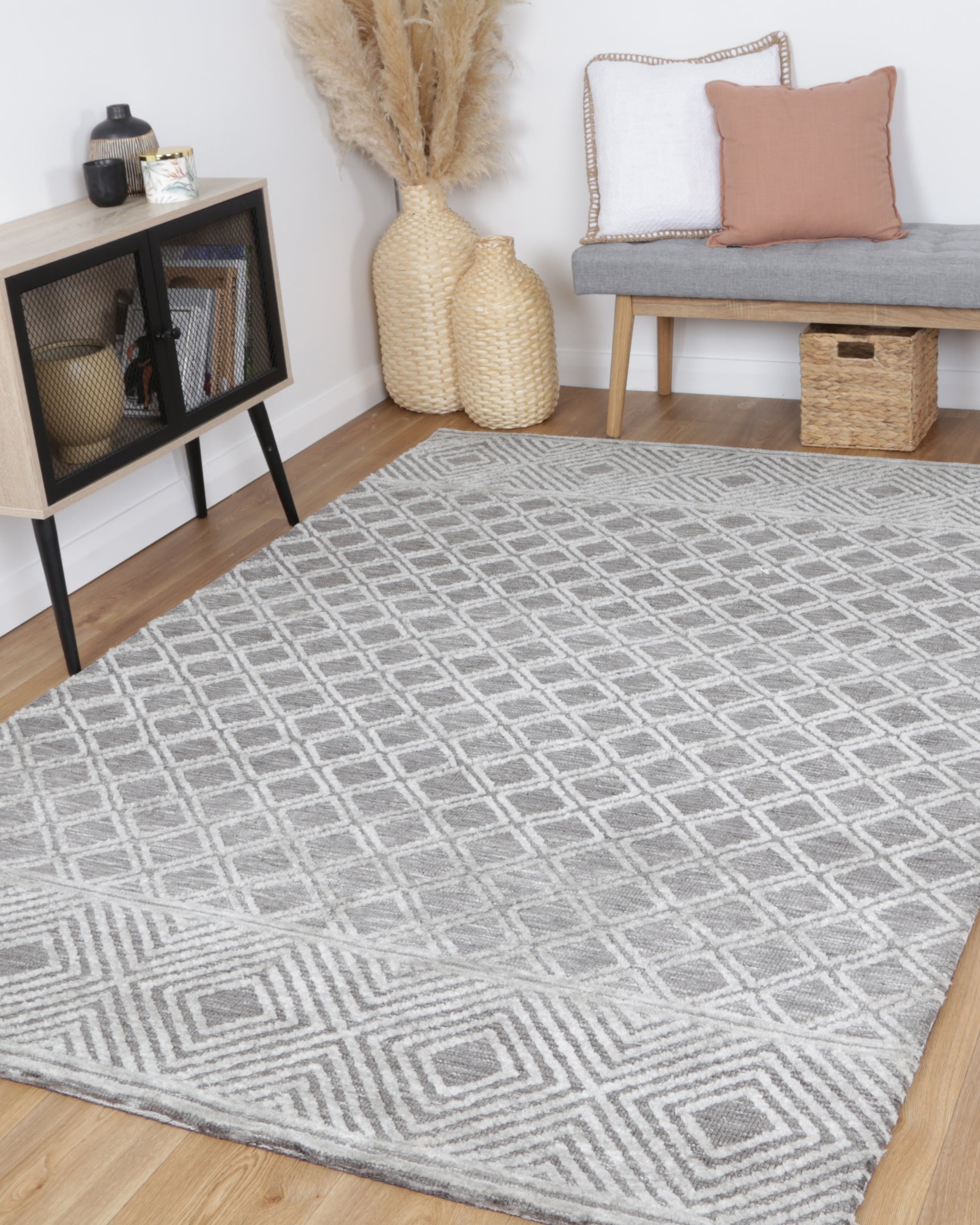 Alayah Diamond Trellis Silver Rug in sitting room with bench plants and wicker basket