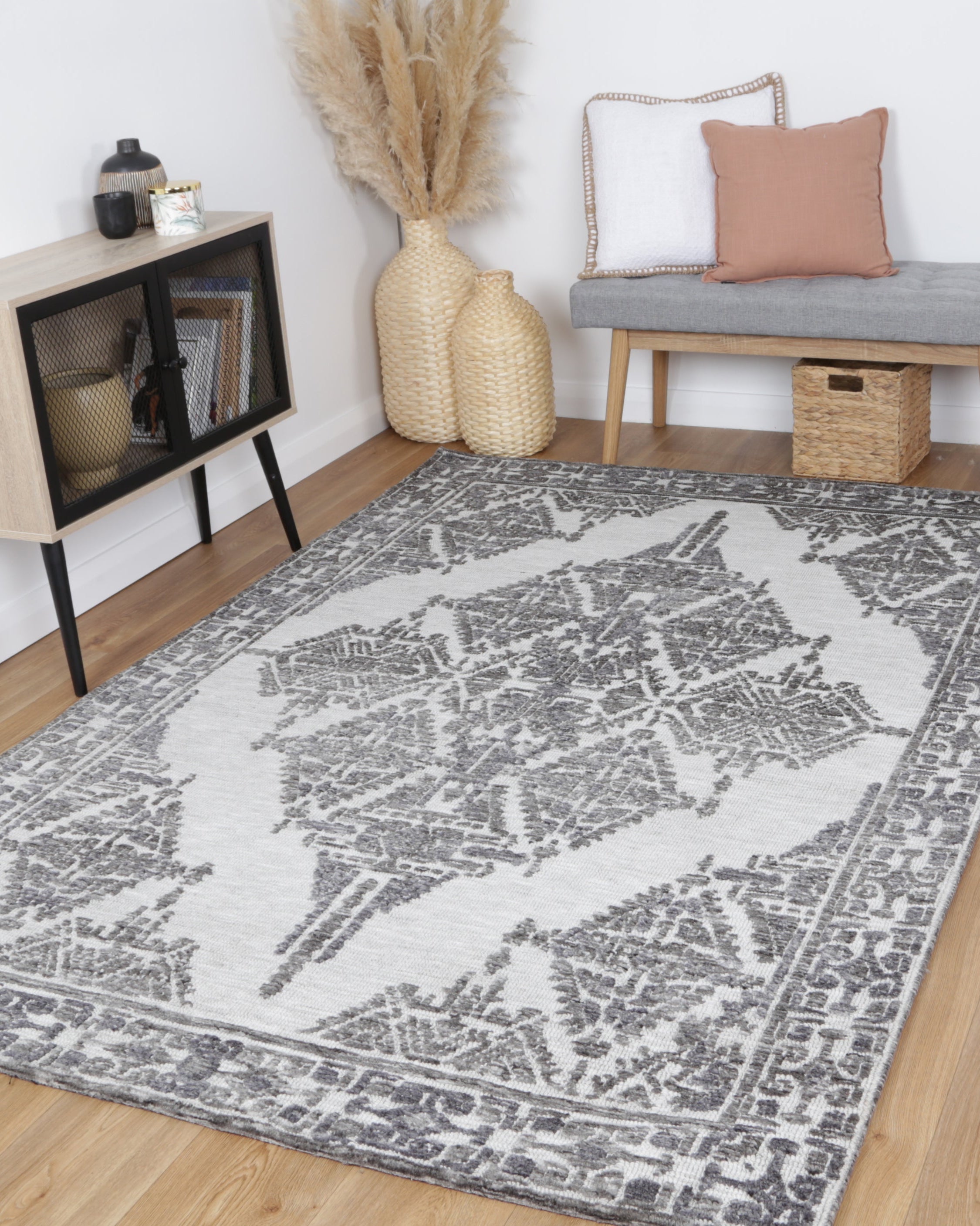 Alayah Ornamental silver Rug in living room with natual flooring and grey bench