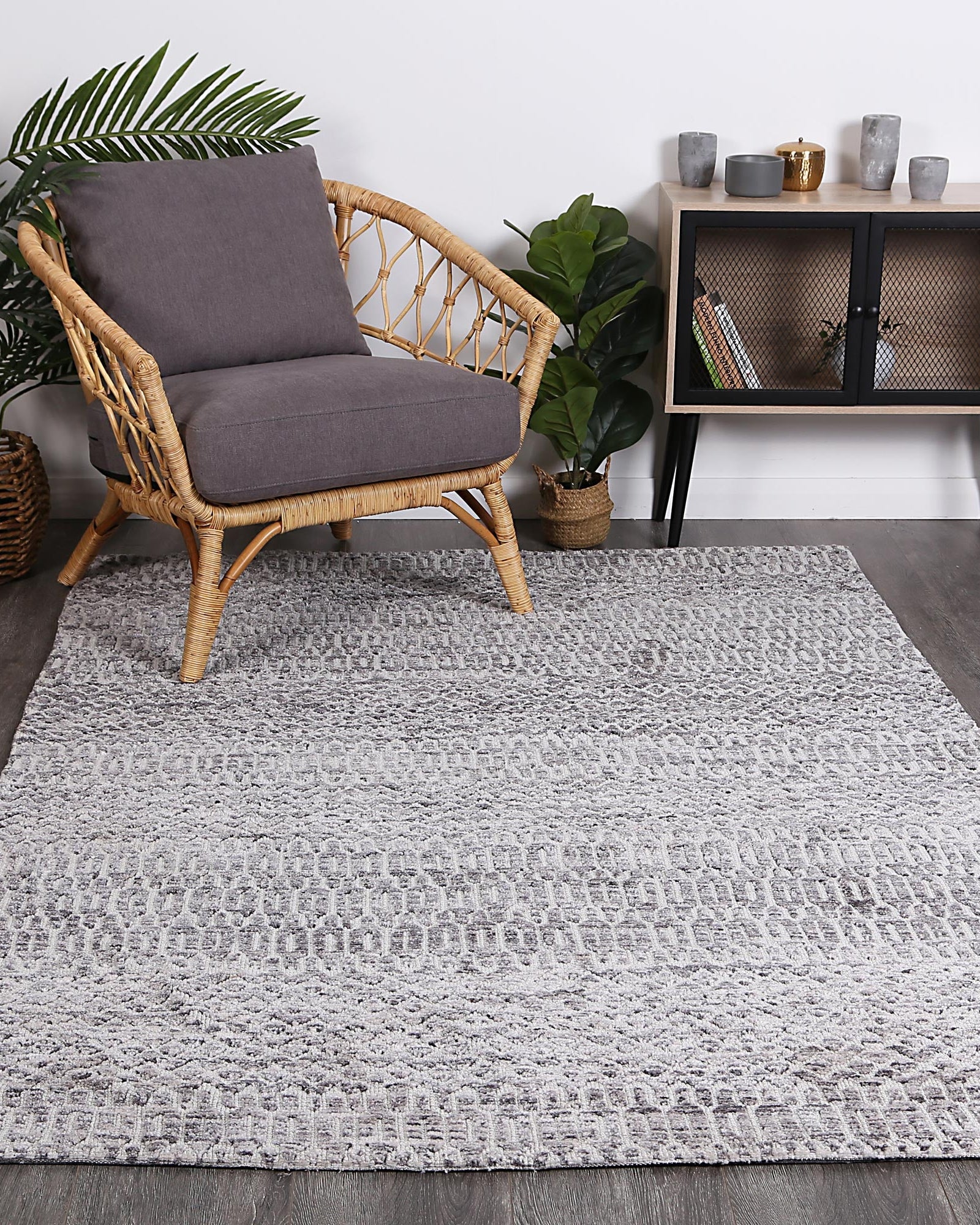 Alayah Camphils Silver Rug in living with green plants on dark flooring