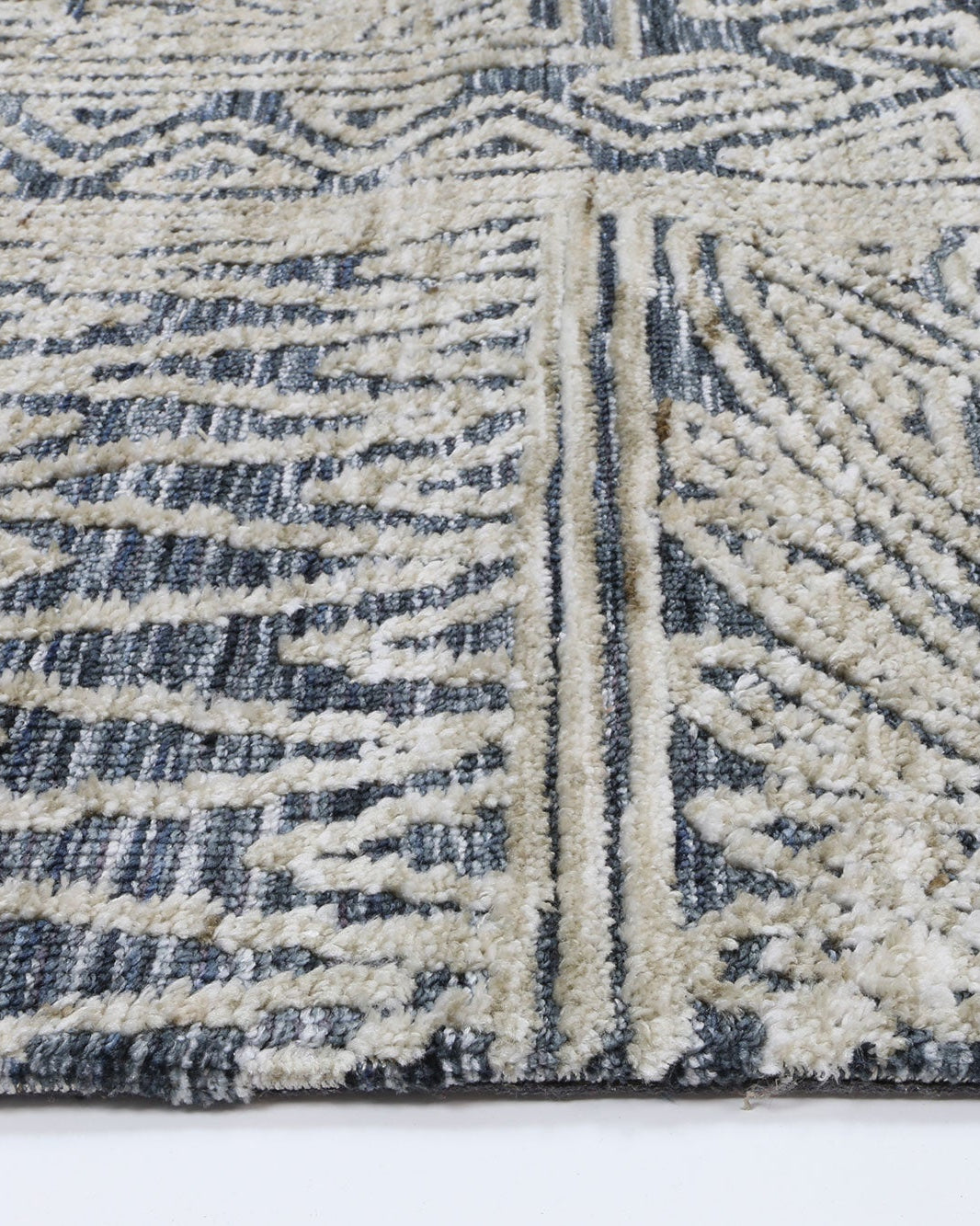 Alayah Charcoal Flower Rug side profile photo white floor